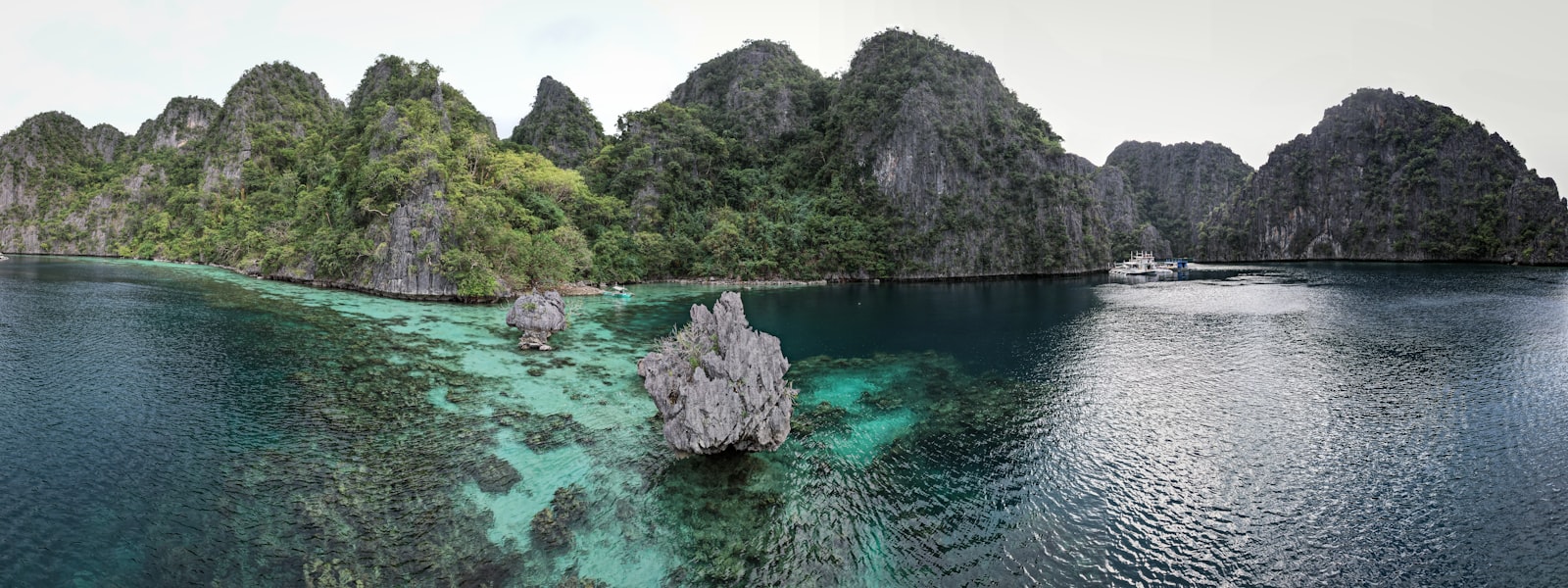 Lush green islands rise from clear turquoise waters.