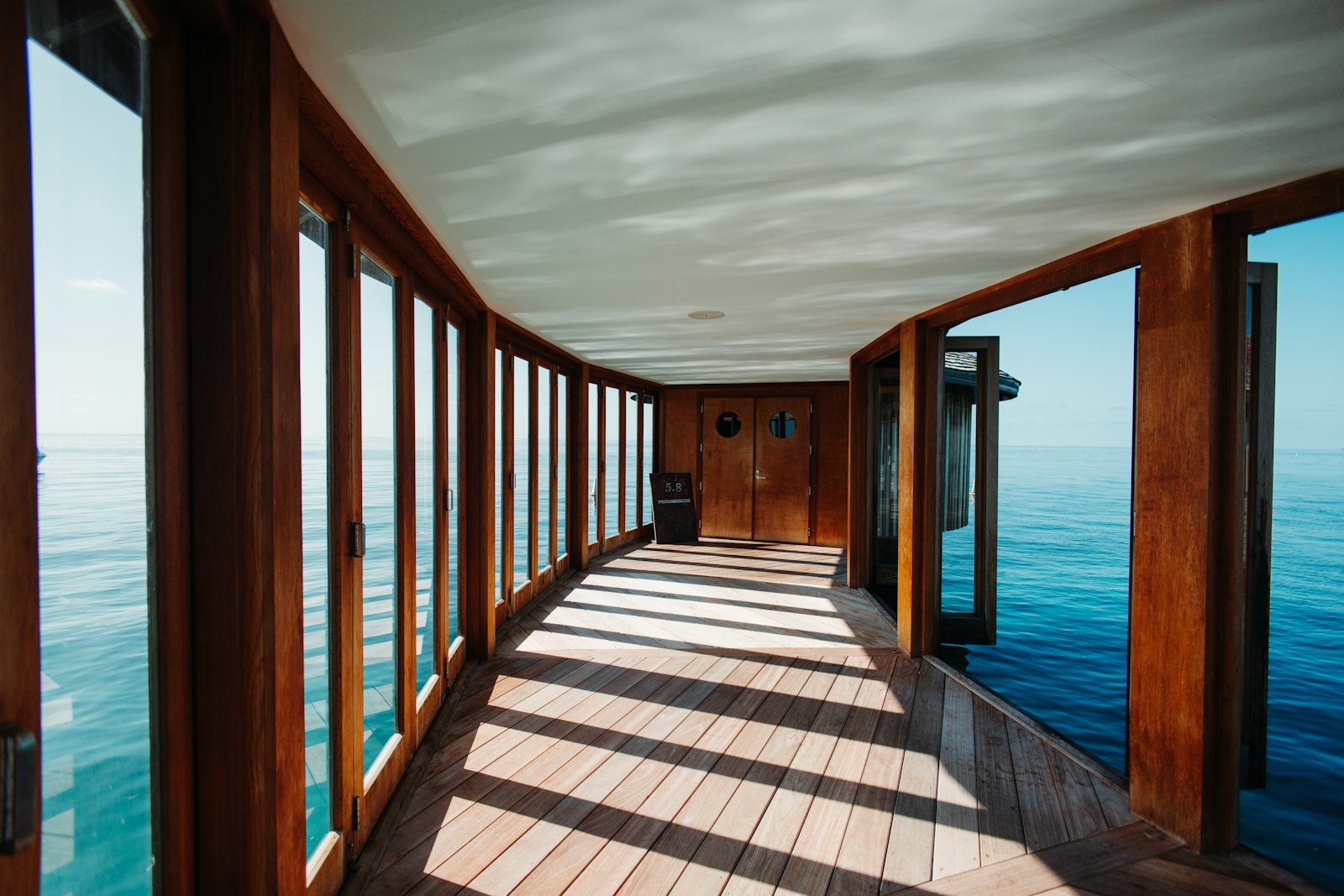 A wooden corridor with ocean views.