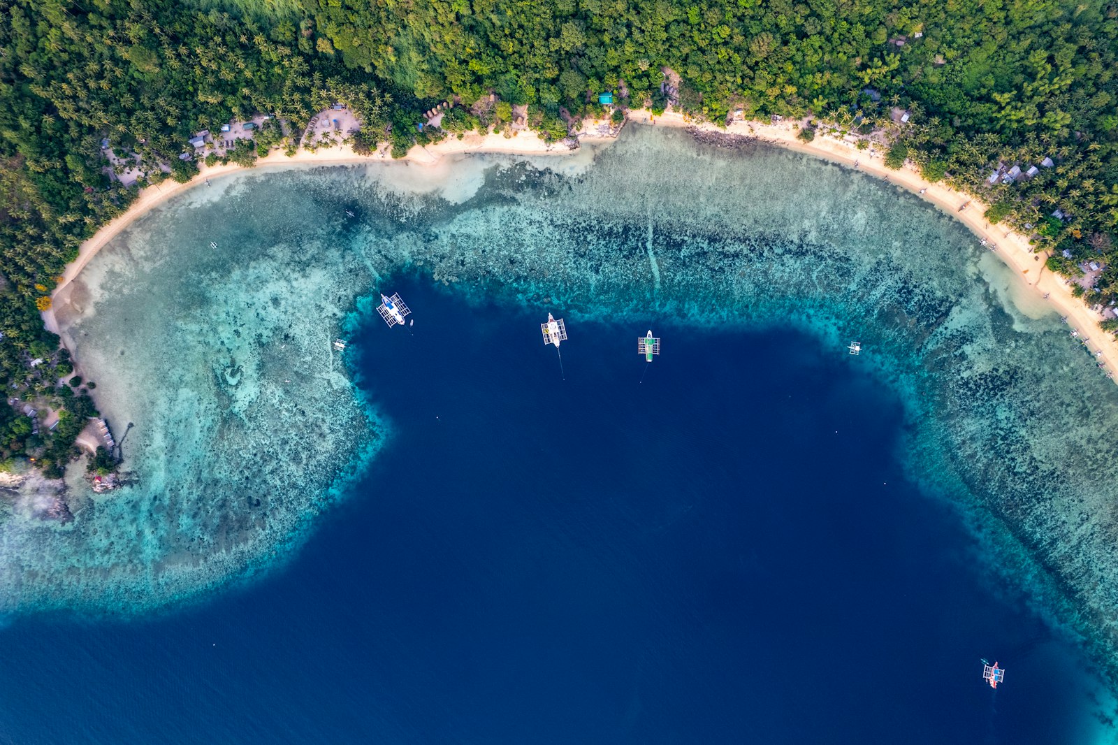 An aerial view of a tropical island with blue water