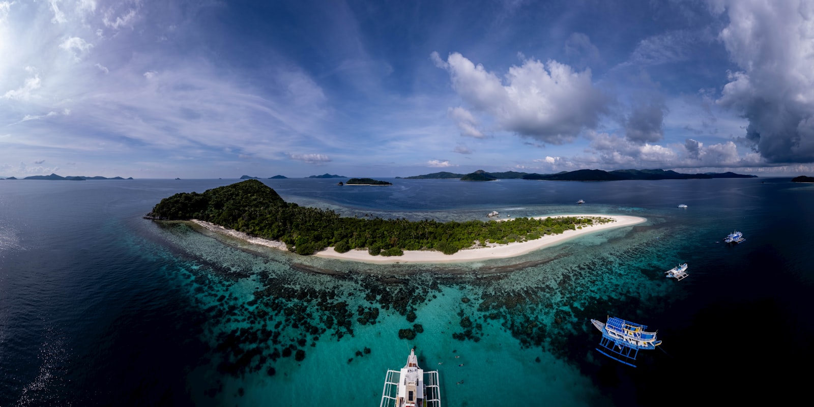 Tropical island with white sand beach and clear turquoise water.