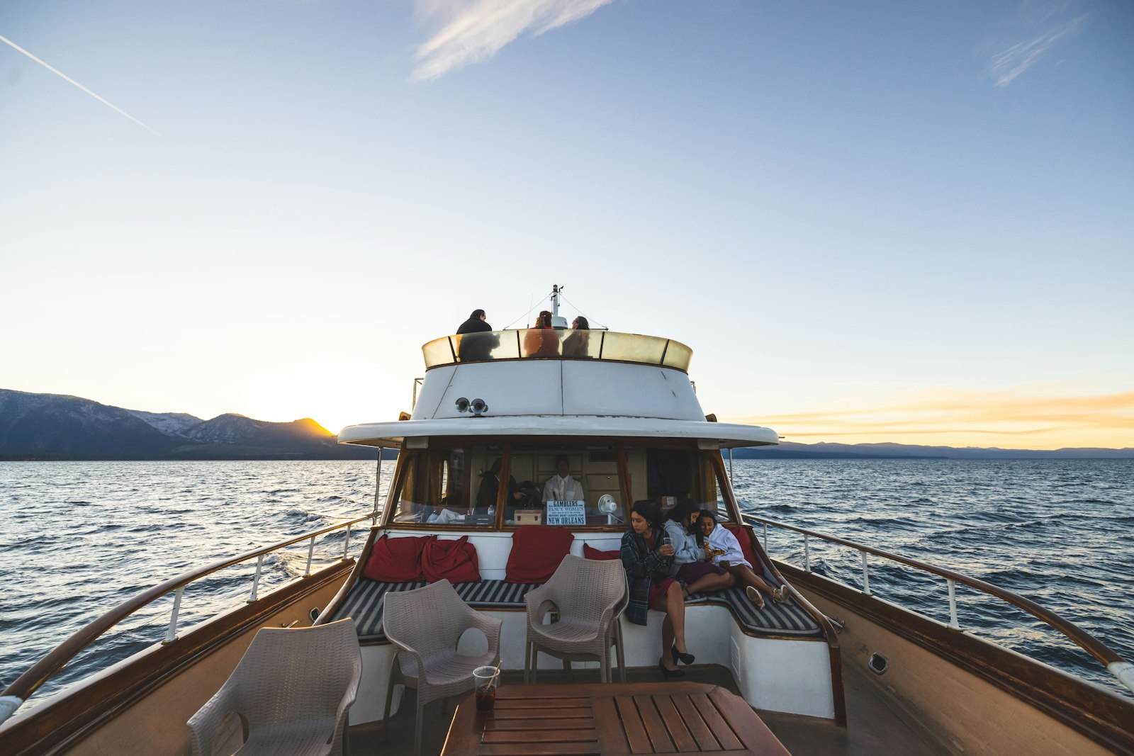 a group of people sitting on the back of a boat